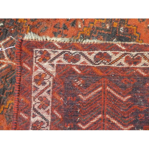 296 - A Persian rug with floral decoration, on a red ground  44