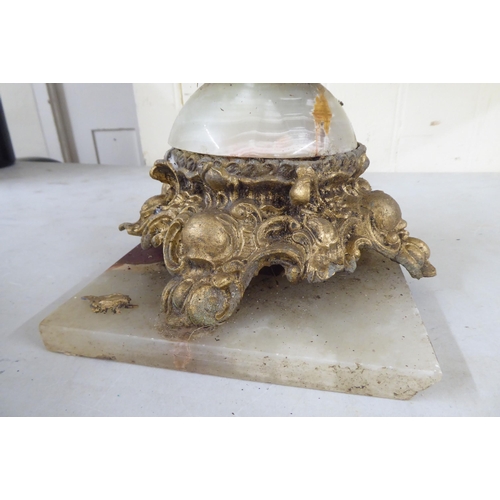 38 - A modern gilt metal and onyx coffee table with opposing cherubic uprights and platform feet  17... 