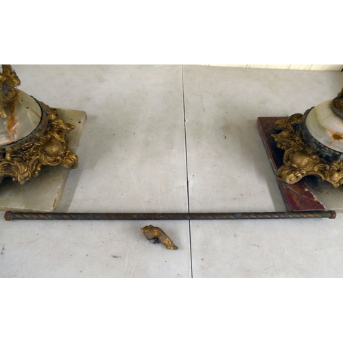 38 - A modern gilt metal and onyx coffee table with opposing cherubic uprights and platform feet  17... 