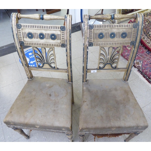 42 - A pair of 19thC French painted beech framed side chairs with rail crests and anthemion splats, the u... 