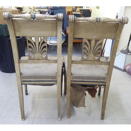 42 - A pair of 19thC French painted beech framed side chairs with rail crests and anthemion splats, the u... 