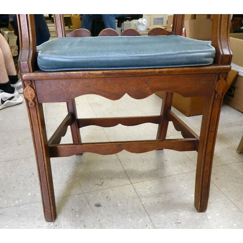 96 - A 19th/20thC country made, oak framed elbow chair with a low ladder back and open, level arms, the s... 