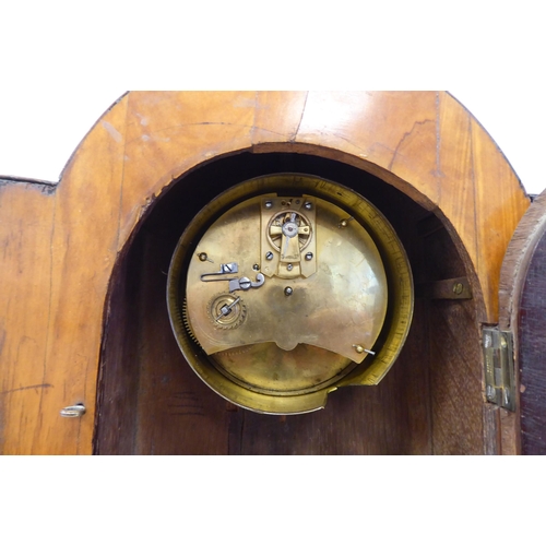 10 - An Edwardian inlaid and floral painted satinwood cased mantel timepiece with a round arch top, foldi... 