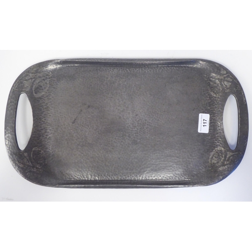 117 - An early 20thC Tudric spot-hammered pewter tea tray with opposing cut-out handles  impressed No... 