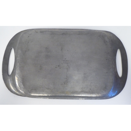 117 - An early 20thC Tudric spot-hammered pewter tea tray with opposing cut-out handles  impressed No... 