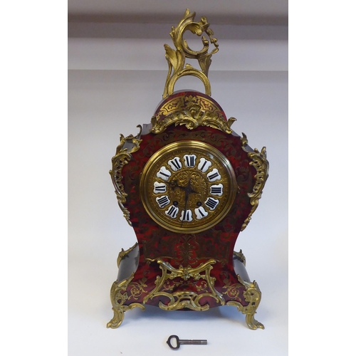 12 - A late 19thC Continental boulleworked and ebonised cased mantel clock of waisted balloon design with... 