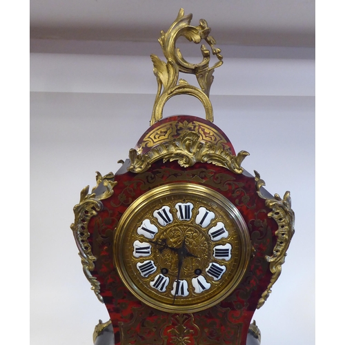 12 - A late 19thC Continental boulleworked and ebonised cased mantel clock of waisted balloon design with... 