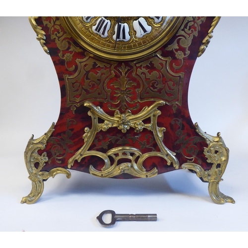 12 - A late 19thC Continental boulleworked and ebonised cased mantel clock of waisted balloon design with... 