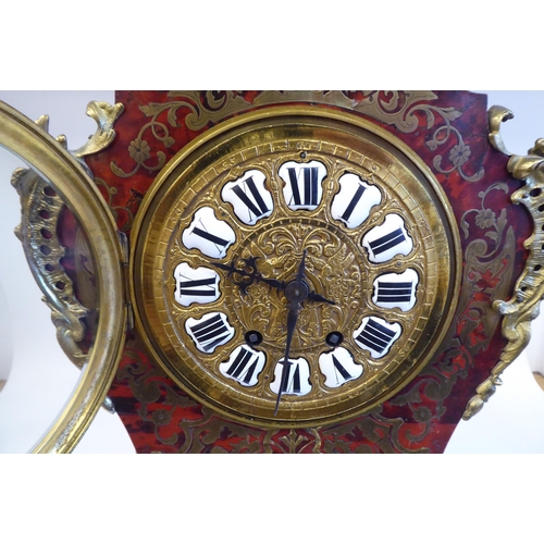 12 - A late 19thC Continental boulleworked and ebonised cased mantel clock of waisted balloon design with... 