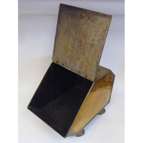 13 - A late Victorian brass coal box with an angled, hinged lid, embossed with flora and foliage