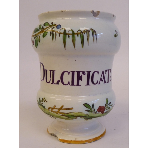 171 - A late 19thC Continental earthenware footed drug jar of waisted form, decorated in trailing flora an... 