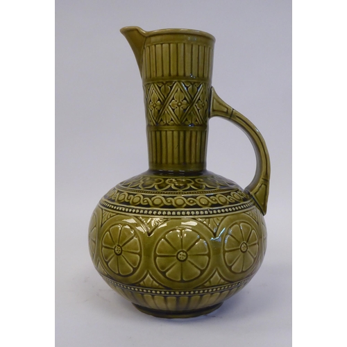 176 - A late 19thC Christopher Dresser for Samuel Lear Art Pottery jug of bulbous form with a narrow neck ... 