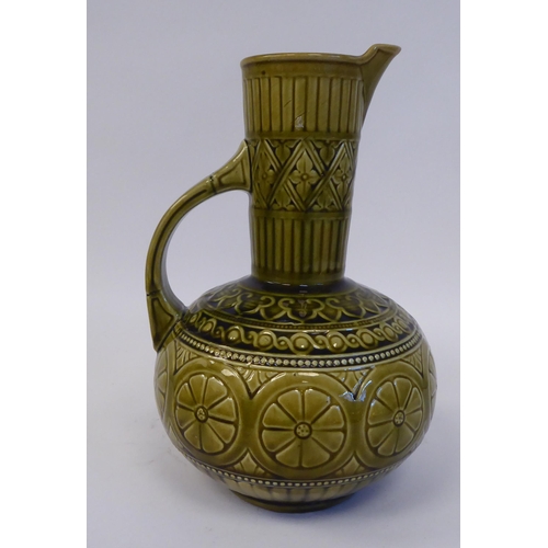 176 - A late 19thC Christopher Dresser for Samuel Lear Art Pottery jug of bulbous form with a narrow neck ... 