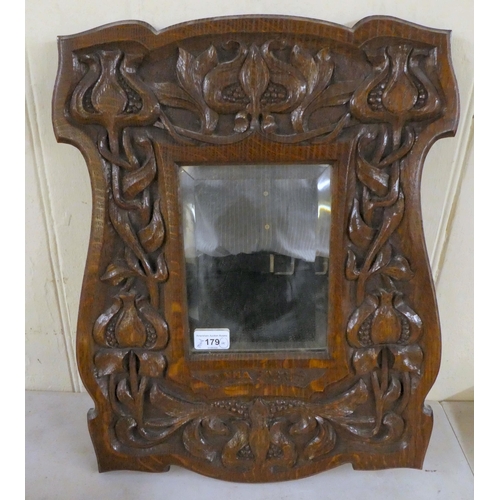 179 - 19thC and later wooden collectables: to include an Art Nouveau period, carved oak framed mirror  20