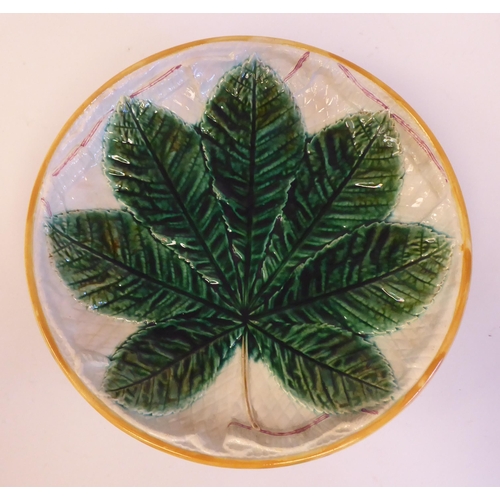 186 - A Victorian Staffordshire majolica comport, decorated with a green leaf, on a trompe L'oeil cloth  b... 