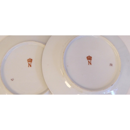 188 - A pair of 19thC Continental porcelain portrait plates, depicting Napoleon and Josephine within extra... 