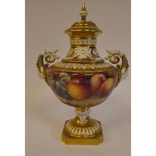 19 - A Royal Worcester china, twin handled pedestal vase and cover, decorated with soft fruit and gilding... 