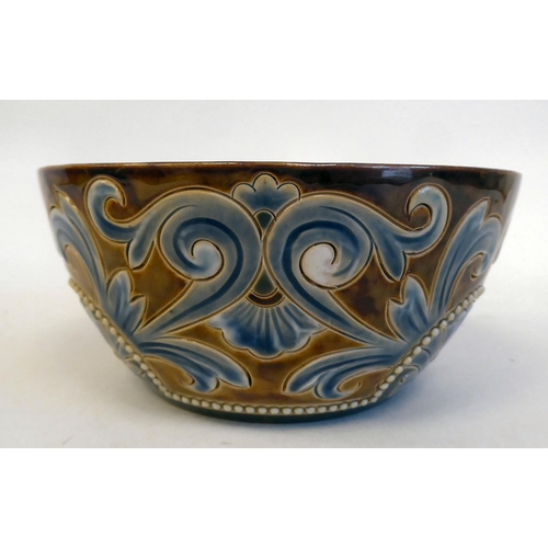 192 - A Doulton Lambeth stoneware bowl, decorated in beadworked and scrolled designs  bears impressed... 