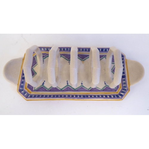 193 - A Poole pottery four division toastrack with octagonal divisions, on a painted tray base