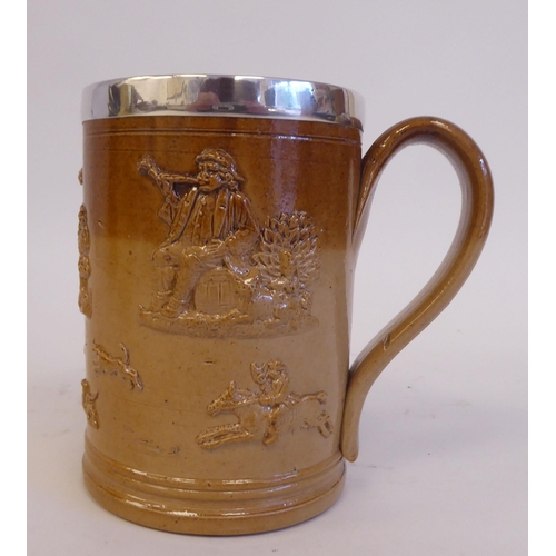 195 - A two tone brown glazed stoneware harvest mug with a loop handle and applied silver rim  maker'... 