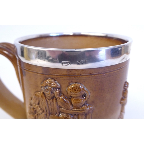 195 - A two tone brown glazed stoneware harvest mug with a loop handle and applied silver rim  maker'... 