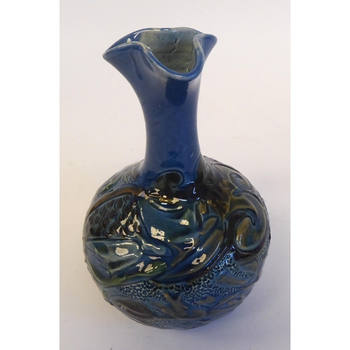 201 - A CH Brannam Barum Ware pottery vase of globular form with a narrow neck and wavy rim, decorated in ... 