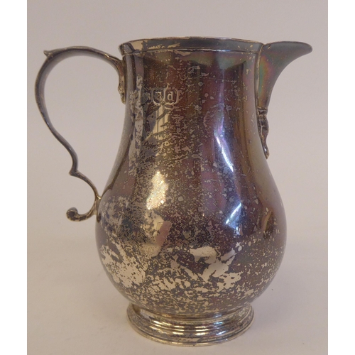 228 - A late Victorian silver sparrow beak, bulbous cream jug with a double C-scrolled handle, on a splaye... 