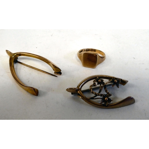 230 - Two 9ct gold wishbone design brooches; and a 9ct gold signet ring