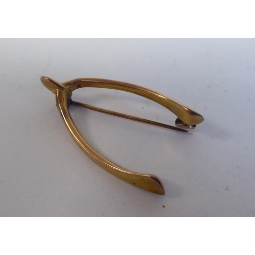 230 - Two 9ct gold wishbone design brooches; and a 9ct gold signet ring