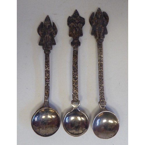 231 - A four piece Anglo-Indian white metal condiments set, cast in vignette panels with religious figures