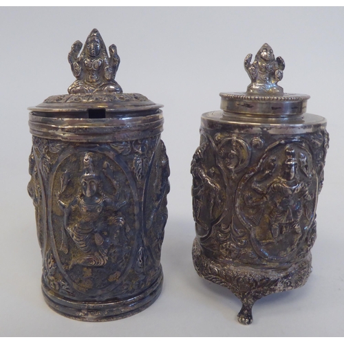 231 - A four piece Anglo-Indian white metal condiments set, cast in vignette panels with religious figures