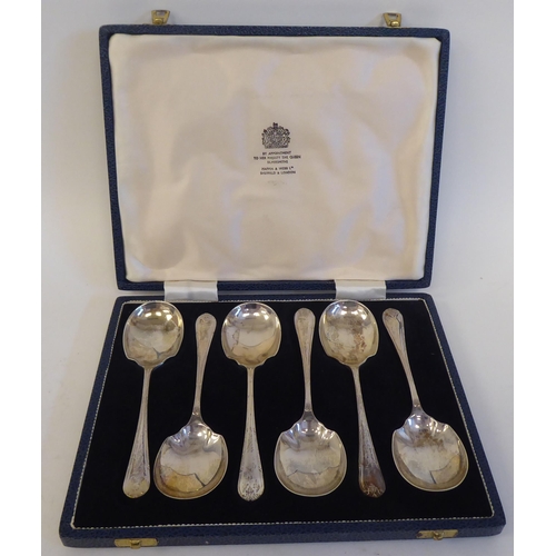 232 - A set of six silver dessert spoons with ribbon tied, applied wire ornament  Mappin & Webb&n... 