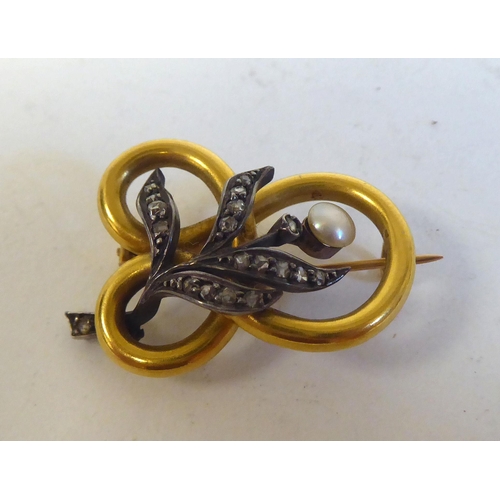 234 - A bi-coloured metal and diamond set brooch