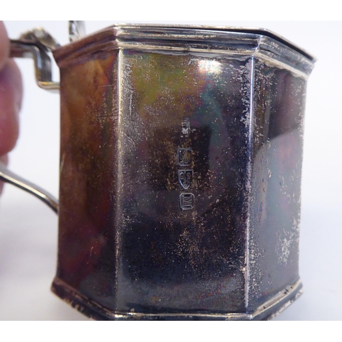 236 - A late Victorian silver, octagonal, drum design mustard pot with a blue glass liner and hinged lid; ... 