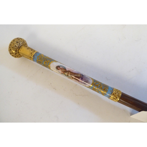 238 - A late 19thC Continental parasol with a painted porcelain handle, depicting a woman playing a musica... 