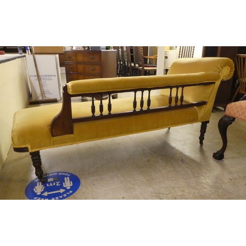 257 - An Edwardian painted oak showwood framed and later fabric upholstered chaise longue, raised on turne... 