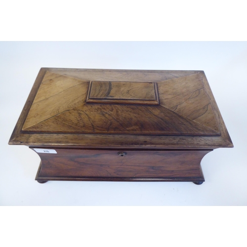 26 - A mid 19thC rosewood tea casket of waisted, sarcophagus form with a lockable hinged lid and opposing... 