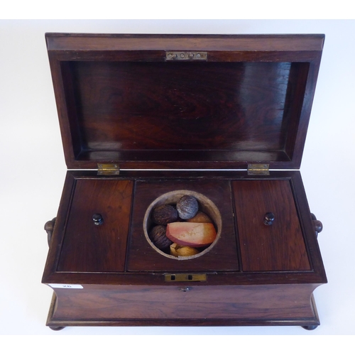 26 - A mid 19thC rosewood tea casket of waisted, sarcophagus form with a lockable hinged lid and opposing... 