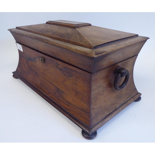 26 - A mid 19thC rosewood tea casket of waisted, sarcophagus form with a lockable hinged lid and opposing... 