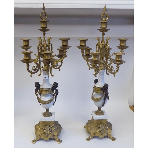 262 - A pair of 19thC style Continental neo-classical lacquered brass and white alabaster candelabra, each... 