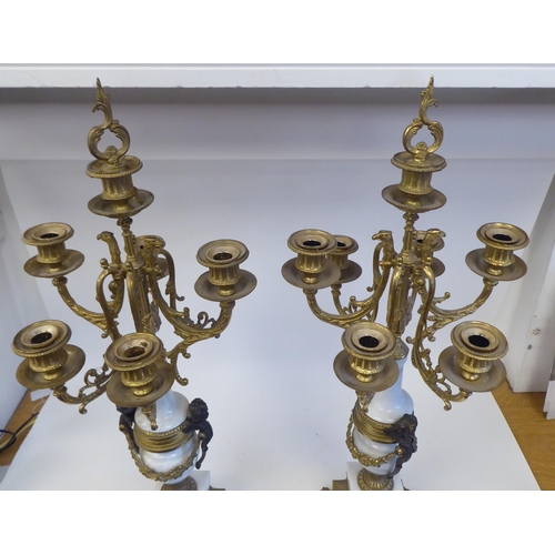 262 - A pair of 19thC style Continental neo-classical lacquered brass and white alabaster candelabra, each... 