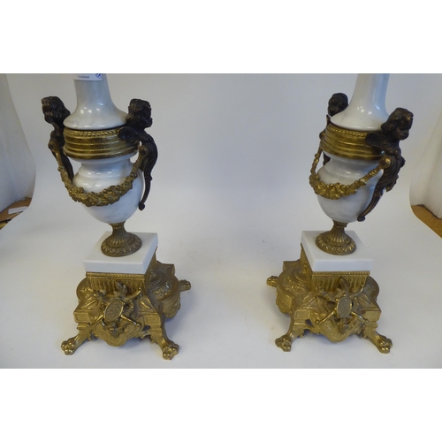 262 - A pair of 19thC style Continental neo-classical lacquered brass and white alabaster candelabra, each... 