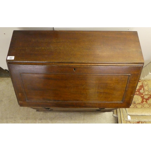 263 - An early 20thC mahogany bureau, the fall flap over three graduated drawers, raised on square, tapere... 