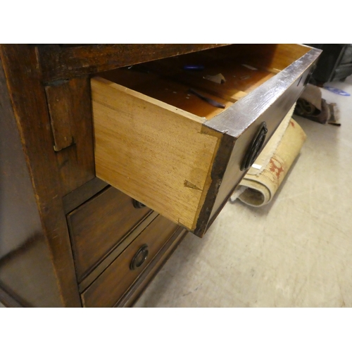 263 - An early 20thC mahogany bureau, the fall flap over three graduated drawers, raised on square, tapere... 