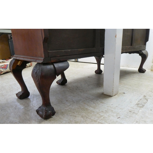 270 - A 1930s mahogany breakfront, bow fronted sideboard with a central bank of three drawers, flanked by ... 