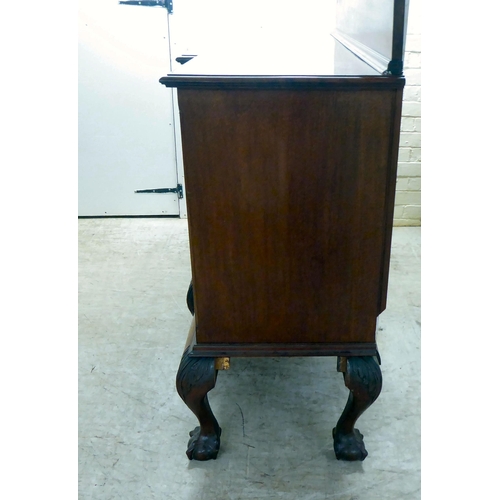 270 - A 1930s mahogany breakfront, bow fronted sideboard with a central bank of three drawers, flanked by ... 