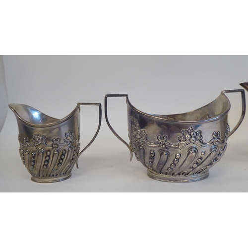 275 - A late Victorian silver four piece tea set of oval, demi-reeded form, comprising a teapot with a swe... 