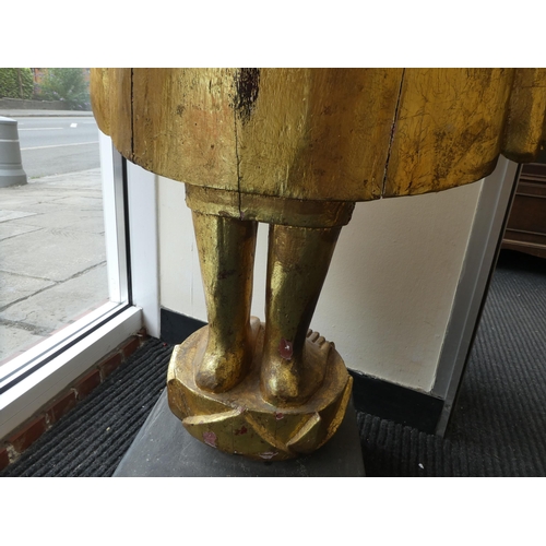 29 - A Burmese carved and gilded teak, standing temple Buddha, holding a myrobalan fruit, on a lotus flow... 