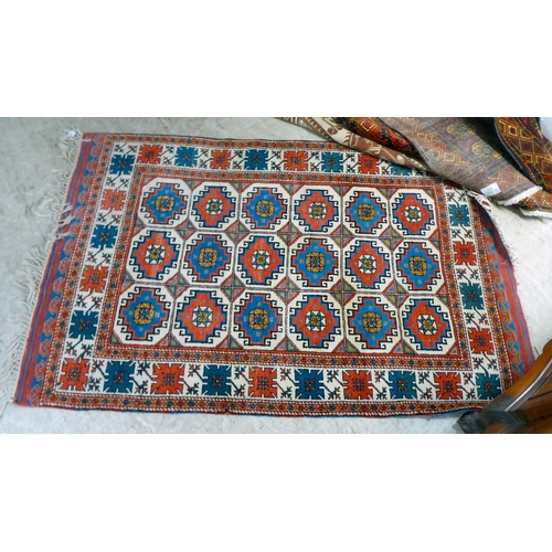 297 - Three dissimilar rugs: to include a Turkish example with repeating box design motifs, on a multi-col... 