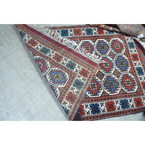 297 - Three dissimilar rugs: to include a Turkish example with repeating box design motifs, on a multi-col... 